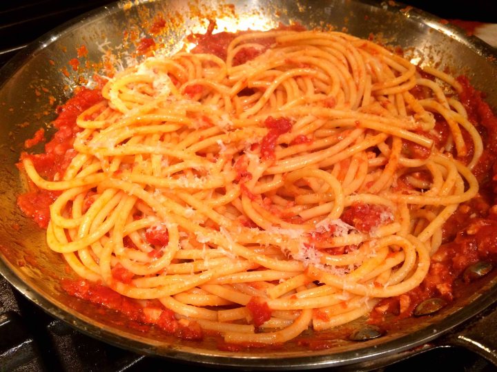 Tossing the pasta with the sauce