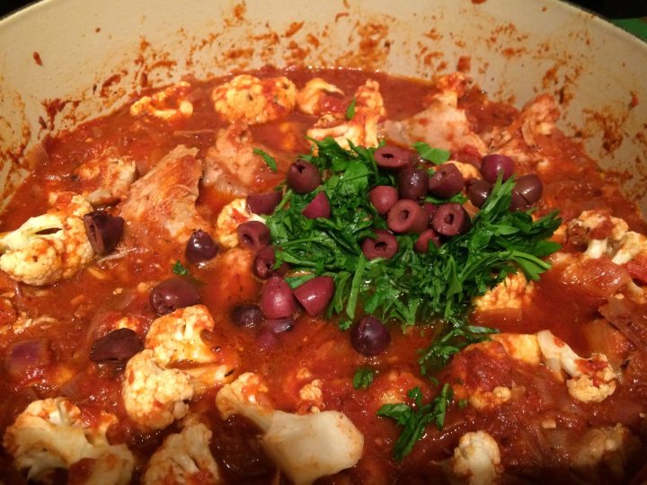 Adding the chicken, cauliflower, parsley, and olives